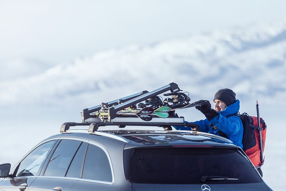 A man loading a ski rack