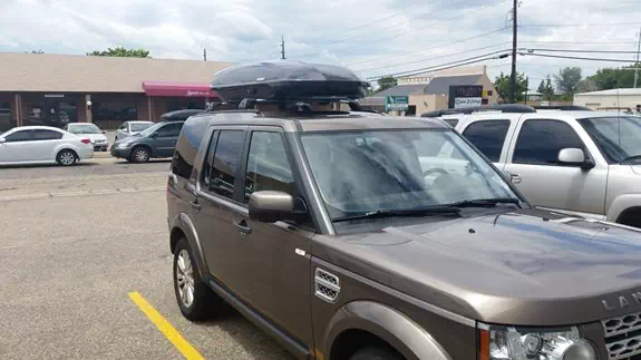 This is a Land Rover LR4 with a whispbar base rack and Yakima Cargo Box