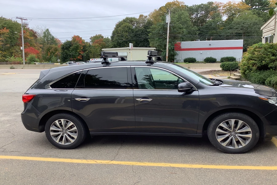 2015 Acura MDX with a Yakima Baseline roof rack system with a Thule Snowpack ski carrier installed.