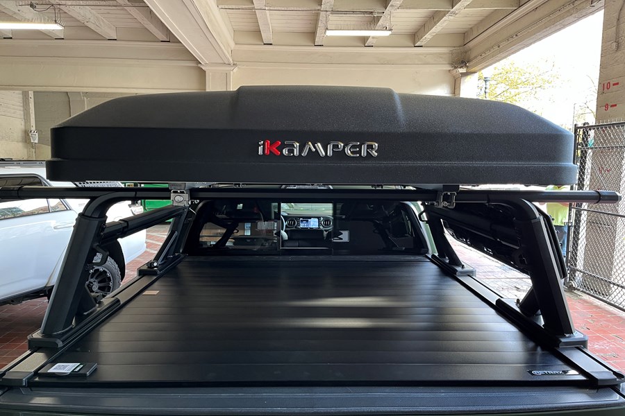 This Toyota Tacoma was fully outfitted with a Prinsu Design Roof Rack over the cab, a Retrax Tonneau Cover with Yakima Overhaul HD system, and an IKamper Mini in Rocky Black.