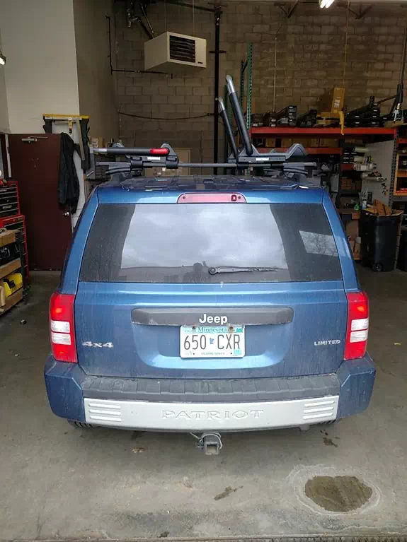 This mid-size SUV is pictured with a entry level Thule square bar system with Yakima J style kayak carriers.