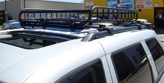 This is a custom 2010 Jeep Grand Cherokee cargo basket roof rack system