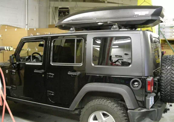 This is a custom 2008 Jeep Wrangler Unlimited 4dr cargo box/cargo carrier roof rack system