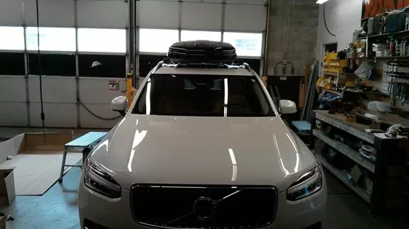 This is a Thule car roof rack with an aerodynamic cargo box installed on a 2016 Volvo XC90